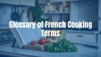 Elegant French kitchen scene with fresh ingredients, a chef's knife, and open cookbook with French terms, warm lighting, realistic.